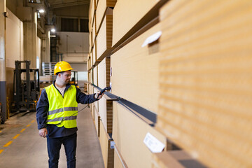 Young man with Down syndrome working in warehouse, scanning products with scanner. Concept of...