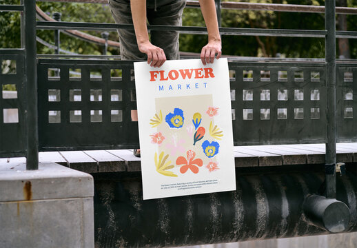 Mockup of woman holding customizable A2 poster by railing
