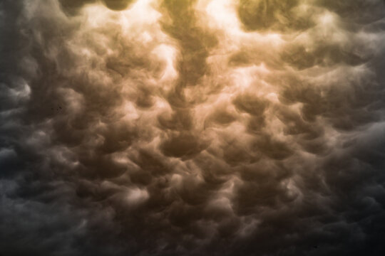 Dramatic mammatus clouds view with sepia tones.