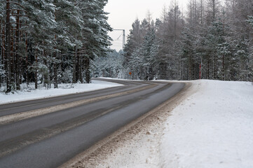 Winter road through forest in Hallsberg Sweden