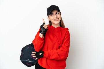 Young sport woman with sport bag isolated on white background pointing up a great idea