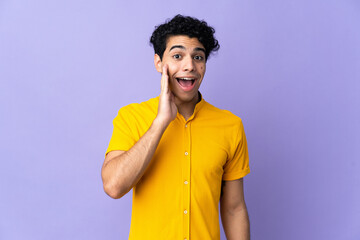 Young Venezuelan man isolated on purple background with surprise and shocked facial expression