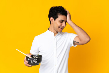 Young Venezuelan man isolated on yellow background has realized something and intending the...