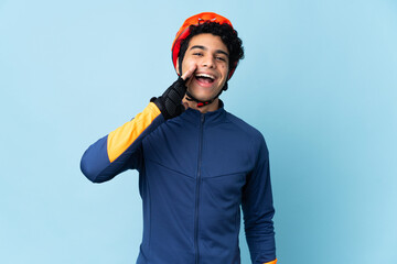 Venezuelan cyclist man isolated on blue background shouting with mouth wide open - obrazy, fototapety, plakaty