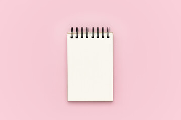 Blank notebook on pink background