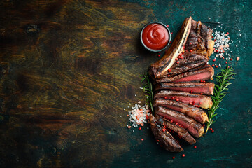 Sliced grilled meat steak Rib eye medium rare set, on wooden serving board. Top view. - obrazy, fototapety, plakaty