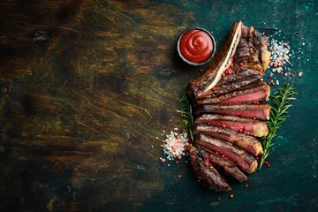 Fotobehang Sliced grilled meat steak Rib eye medium rare set, on wooden serving board. Top view. © Yaruniv-Studio