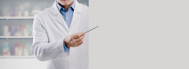 Doctor showing a blank sign and pointing with a pen