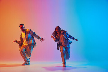 Dynamic duo, man and woman, mid-dance in vibrant neon against gradient backdrop. Lively, rhythmic...