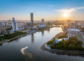 Yekaterinburg city and pond aerial panoramic view at summer sunset.