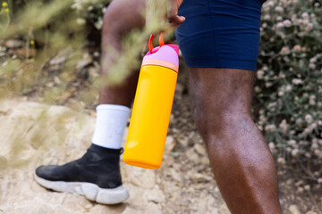 Black African American Holding a Yellow Tumbler While Hiking in Rocky Mountain during Daylight