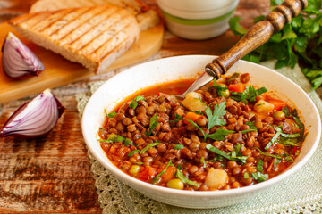 Homemade brown lentil stew with carrots, onions and tomatos. Comfort  winter food.
