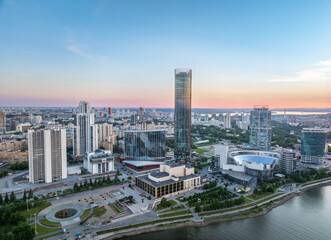 Fototapeta na wymiar Yekaterinburg city with Buildings of Regional Government and Parliament, Dramatic Theatre, Iset Tower, Yeltsin Center, panoramic view at summer sunset.