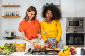 Diversity young happy love LGBT, LGBTQ caucasian and african family lesbian couple woman cook vegan...