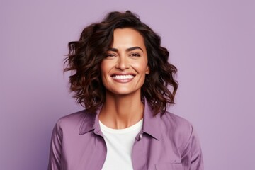 Portrait of happy smiling young woman in casual clothes, over violet background.