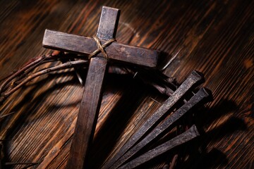 Christian cross with crown thorns on dark background.
