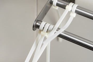 Tightened plastic fastening cable ties on metal structures