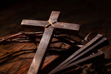 Christian cross with crown thorns on dark background.
