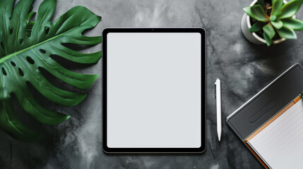 Tablet with Blank Screen Surrounded by Plants , Modern tablet with a blank screen ready for presentation, surrounded by lush green plants on a grey concrete background.	