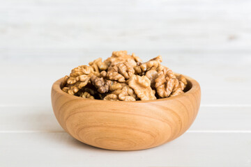 Fresh healthy walnuts in bowl on colored table background. Top view Healthy eating bertholletia concept. Super foods
