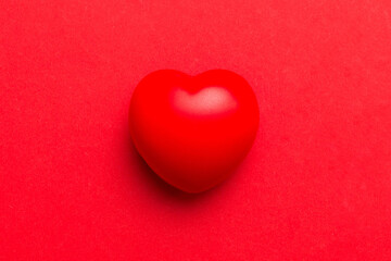 red heart shape on colored background. minimal concept top view with copy space