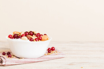 Healthy breakfast food with granola, yogurt, fruits and nuts. Dessert parfait with dried fruits for breakfast