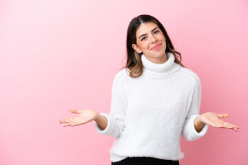 Young Italian woman isolated on pink background having doubts