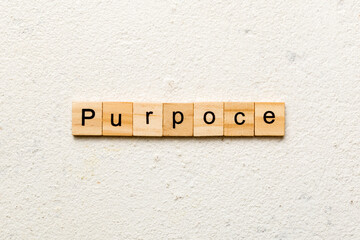 purpose word written on wood block. purpose text on table, concept