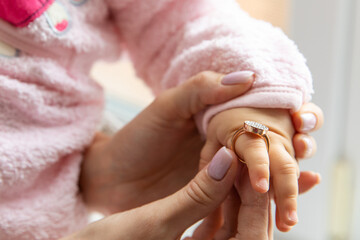 Beauty and fashion concept. Mother's ring on her little daughter's finger. little fashion-girl....