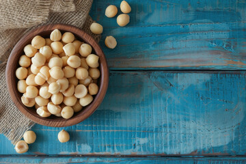 Fototapeta na wymiar Wooden Bowl Filled With White Beans on Blue Table