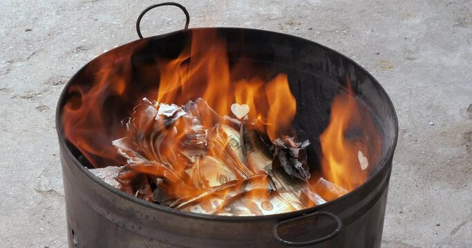 close up of people burns joss paper money for the Chinese New Year celebration as a way of ringing in good fortune for the year ahead