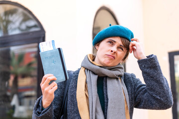 Brunette woman holding a passport at outdoors