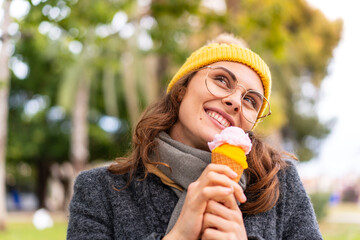 Brunette woman with a cornet ice cream at outdoors
