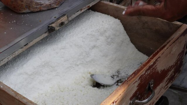 Making kue putu, an Indonesian traditional cake made from coconut and brown sugar