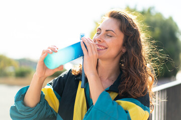 Young sport woman at outdoors with a bottle of water