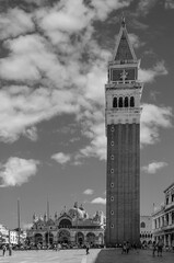 Fototapeta na wymiar Beautiful black and white vertical view of Piazza San Marco square in a moment of tranquility on a sunny summer day, with a picturesque sky, Venice, Italy