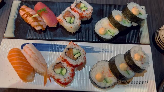 Sushi and rolls in plate. Close-up of sushi rolls on rectangle sushi plate. 