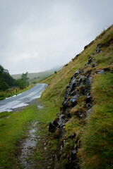 wet read through mountains and green hills