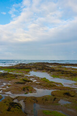 beautiful sandy beach with a cloudy sky