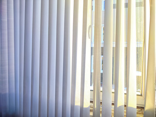 A view of a window adorned with clean white curtains window blind against a simple backdrop. Background, texture, pattern, frame, copy space