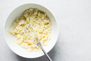 Top view of Creaming butter and sugar with a whisk, the process of making a cake, overhead view of...