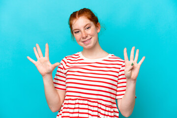 Fototapeta premium Young reddish woman isolated on blue background counting nine with fingers