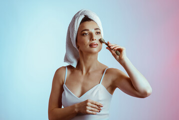 A young woman massaging her face with a roller. Facial Skin Care. Healthy, glowing skin