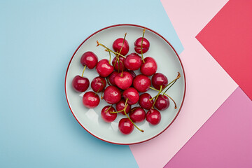 Fresh Cherries on a Plate with Trendy Color Block Background