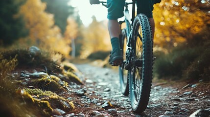 Close-up of a mountain biker's ride along a forest trail at dusk, capturing the essence of...