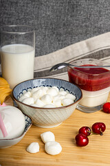 Celebrating the Jewish holiday Shavuot. Kosher fresh dairy products, milk and cheese, wooden background. Dairy products on a wooden background.