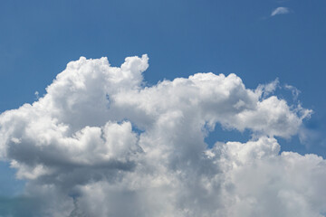 a visible mass of condensed water vapor floating in the atmosphere, typically high above the ground.
