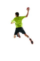 Fototapeta premium Full-length image of young handball athlete in motion during game, throwing ball against white studio background. Motivation to win. Concept of professional sport, tournament, competition