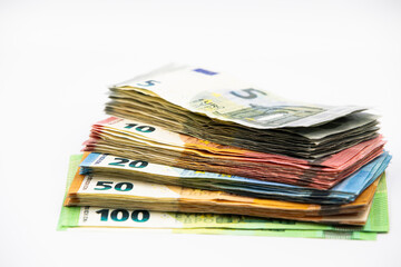 Pile of euro banknotes of 100, 50, 20, 10 and 5 euros. White background