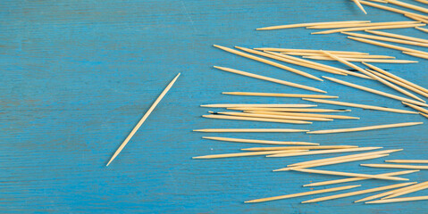 Wooden toothpicks on the blue background.